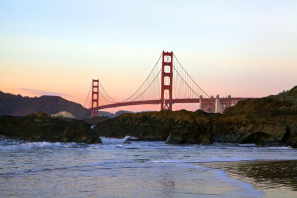San Francisco Golden Gate Bridge against sunset sky wotj [oml c;pids amd water om tje fpregrpimd