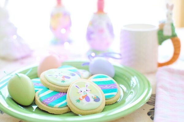 plate of Easter egg-shaped sugar cookies with colorful icing