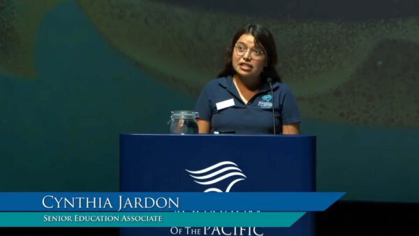 Senior Education Associate Cynthia Jardon speaks from the Aquarium of the Pacific lectern