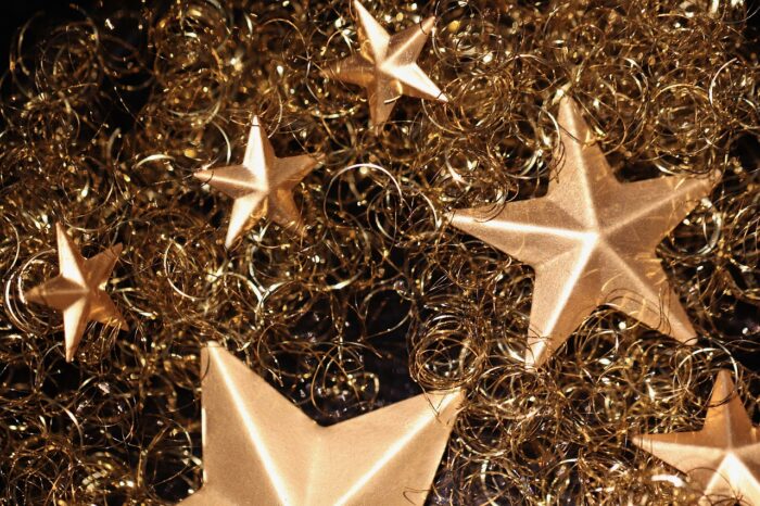 Multiple gold stars on a Chrsitmas tree
