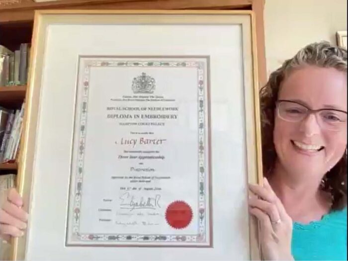 San Francisco School of Needlework and Design Co-Founder Lucy Barter smiles as she displays her diploma from England's Royal School of Needlework