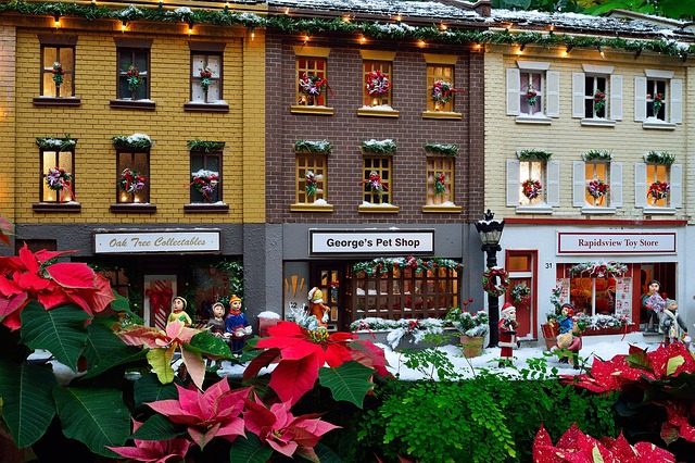 Miniature of small independent shops with shopers and Christmas poinsettias in front of them