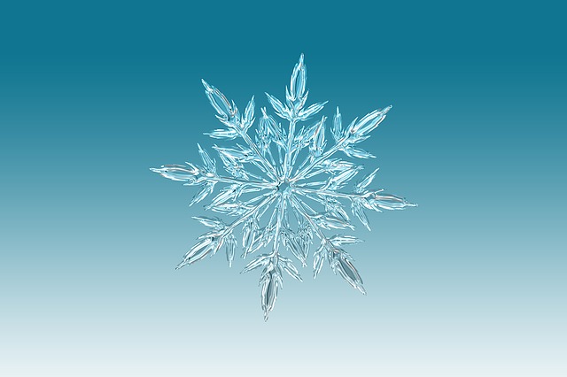 White translucent snowflake against a blue-and-white gradient background
