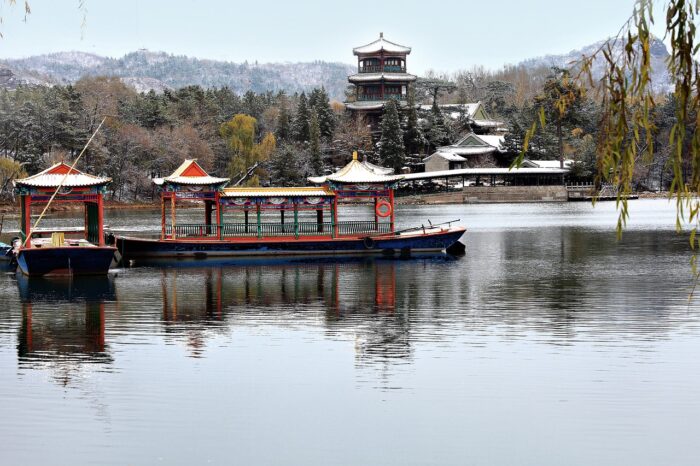 Jinshan Pavilion reflected in water with a mountain in the background