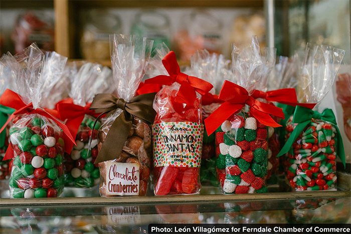 Bags of handcrafted candies sit on a shelf.