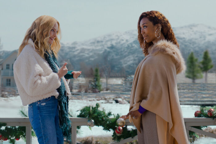 Jackie and Charlotte face each other against a snowy background.