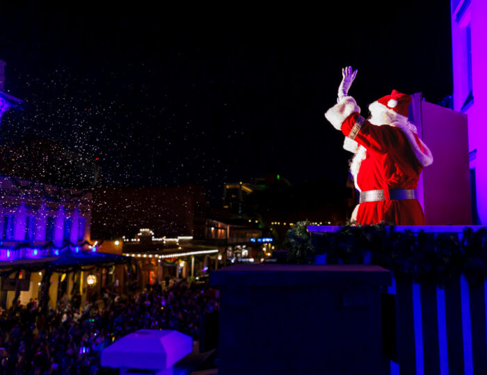 Santa waves from a balcony in Old Sacramento during Theatre of Lights