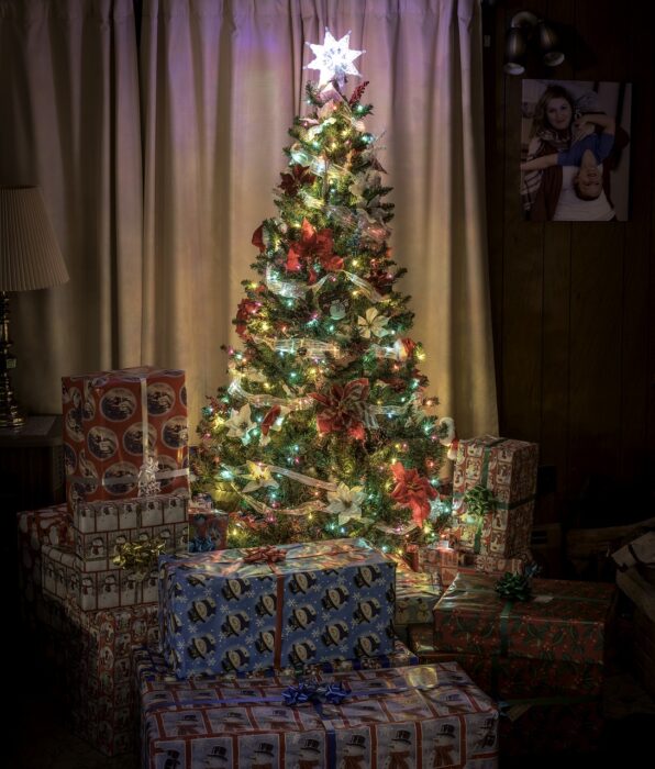 Lighted vintage Christmas tree with packages under it