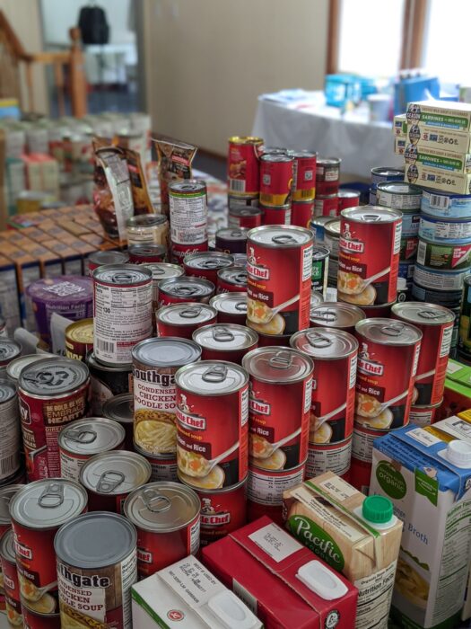 Stacks of canned goods next to a window