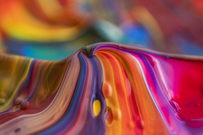Swirls of multicolored paint in an abstract mountain.