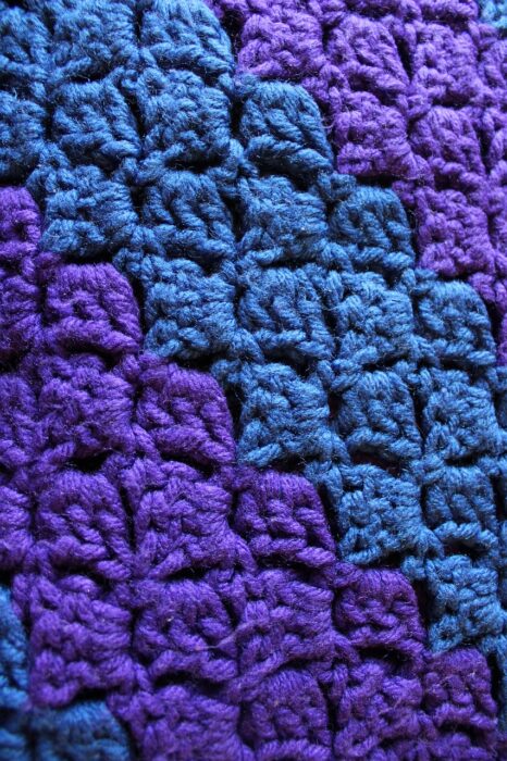 Purple-and-blue crocheted wool fabric.