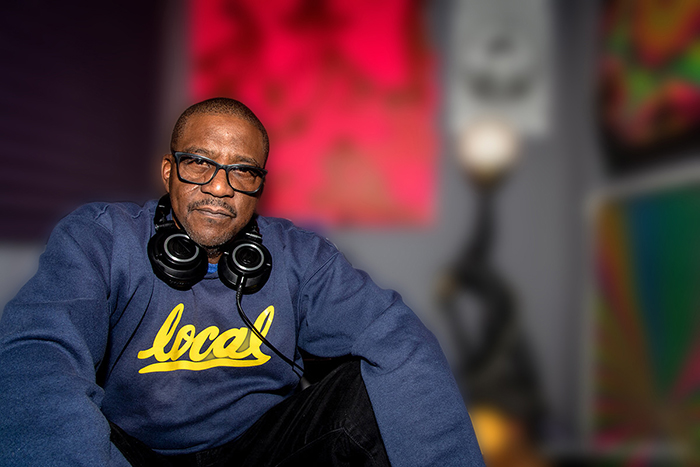 Michael Marshall, in a navy blue sweatshirt with "local" in lowercase gold script, looks into the camera against a blurred background.