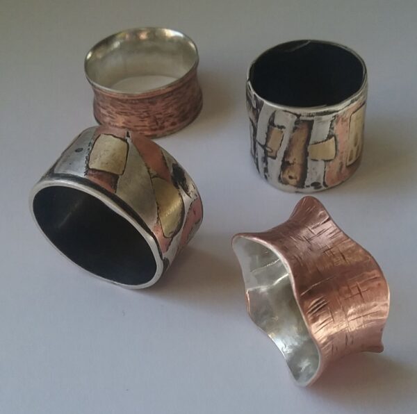 Hand-hammered metal cuff bracelets in copper, silver and gold colors.