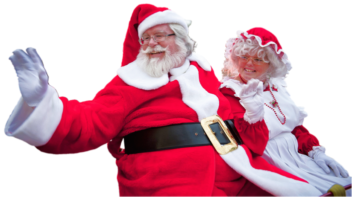 Smiling Santa in a red suit waves a white-gloved hand as Mrs. Claus smiles next to him.