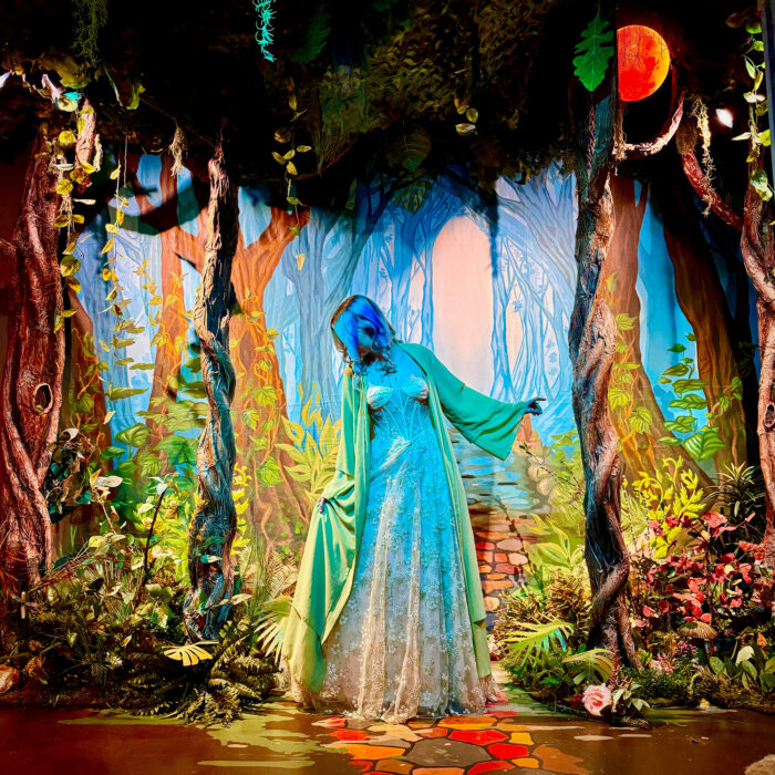 Painting of a blue woman ghost in an enchanted forest