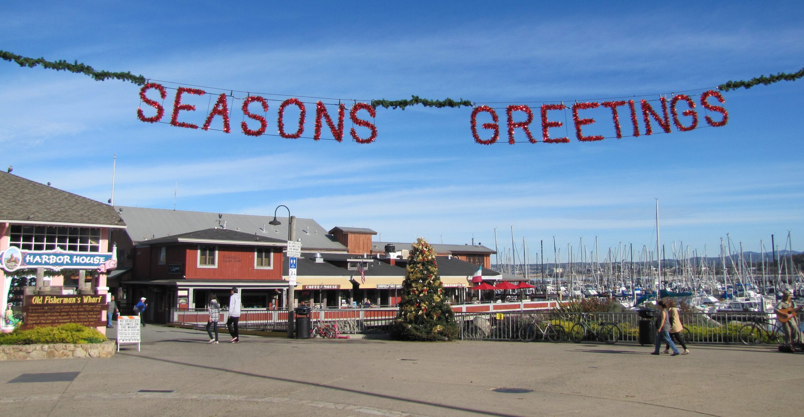 Red "Seasons Greetings" garland over Monterey's Old Fisherman's Wharf