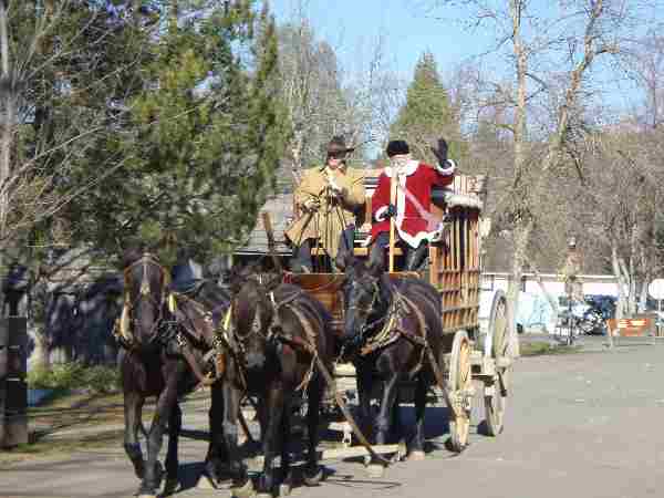 St. Nicholas waves from atop a stagecoach as he rides into Columbia.