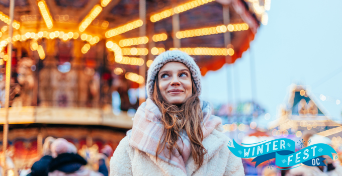 Woman smiles next to carousel with "Winter Fest OC" nearby.