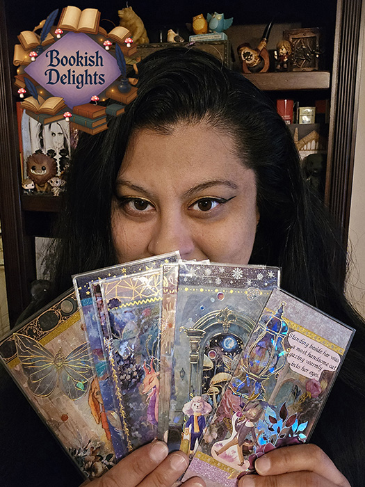 Teresa fans bookmarks in front of her face like a deck of mystical cards.