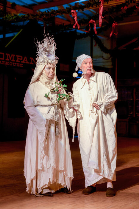 The Ghost of Christmas Past ushers a wide-eyed Scrooge through his memories.