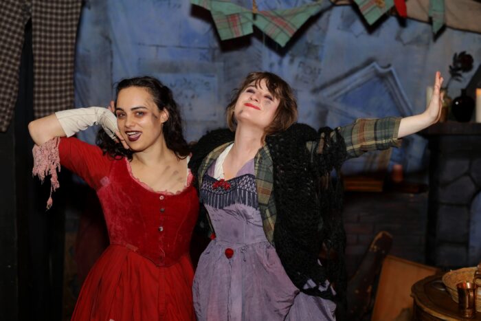 Nancy and Nell, in their finery, smile at passersby.