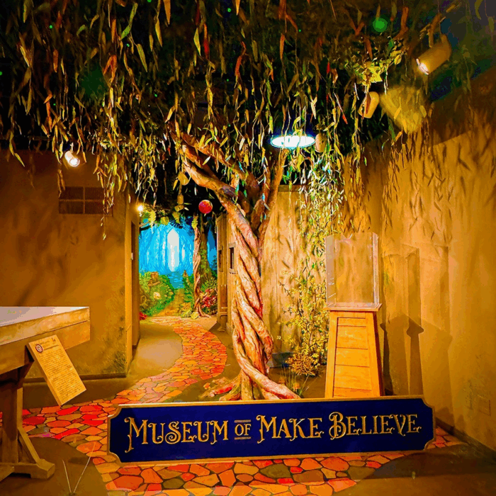 Enchanted tree and "cobblestone" paved road lead into Museum of Make Believe.