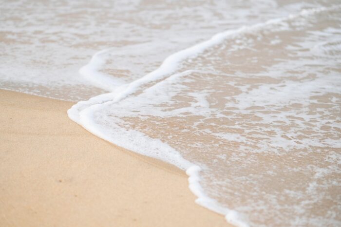 Ocean ebbs at the sand.