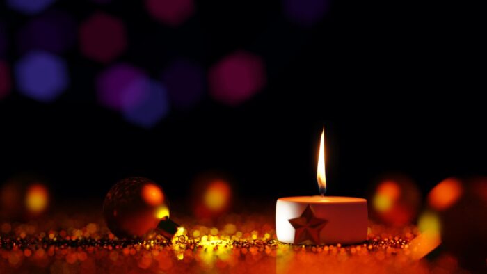 Small votive candle with a star on its base